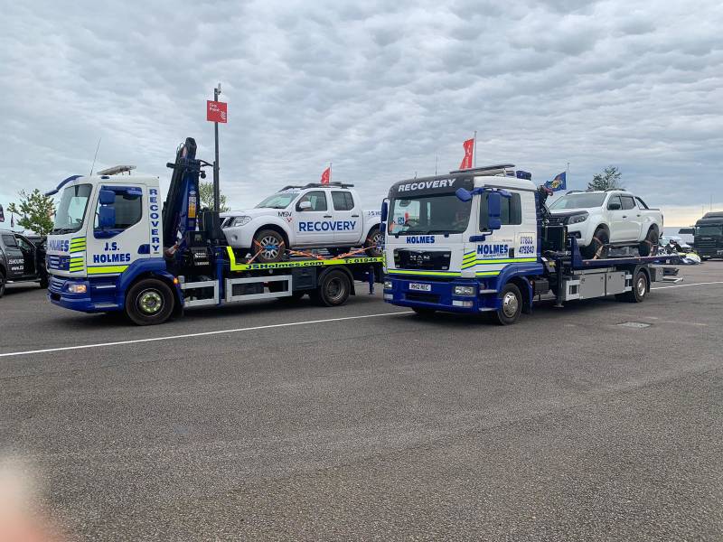 J.S. Holmes recovery trucks in a parking lot. 